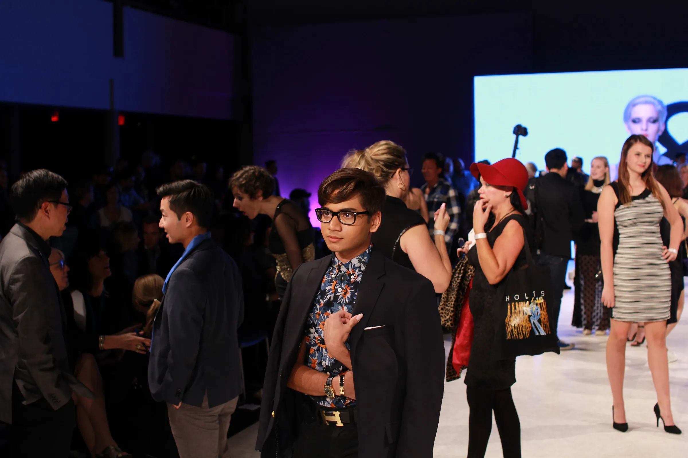 Guests mingling at the end of a fashion show runway